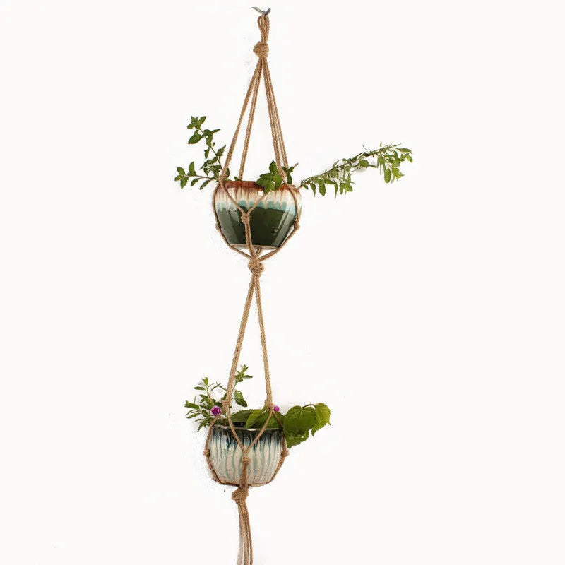 Woven wire basket made of cotton rope shown in a desktop setting.