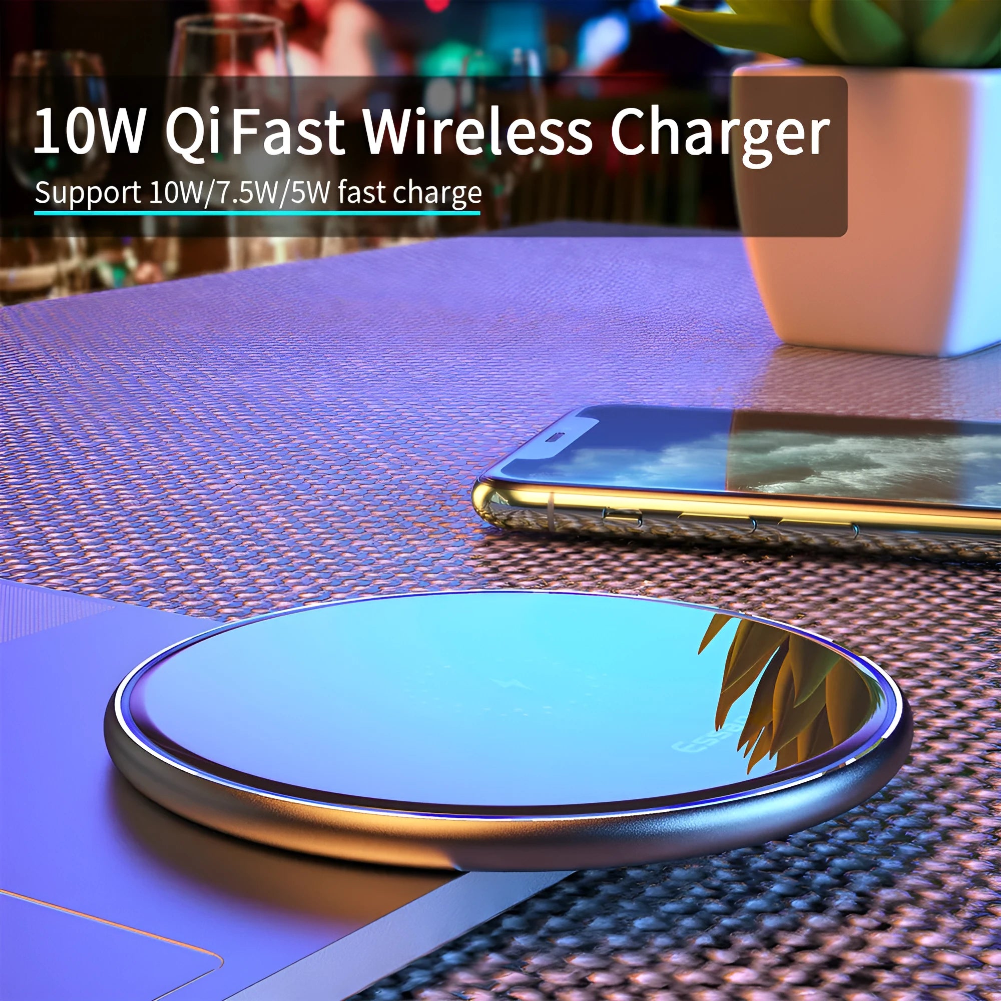Black aluminium alloy Qi wireless fast charging pad for phones on a wooden desk.