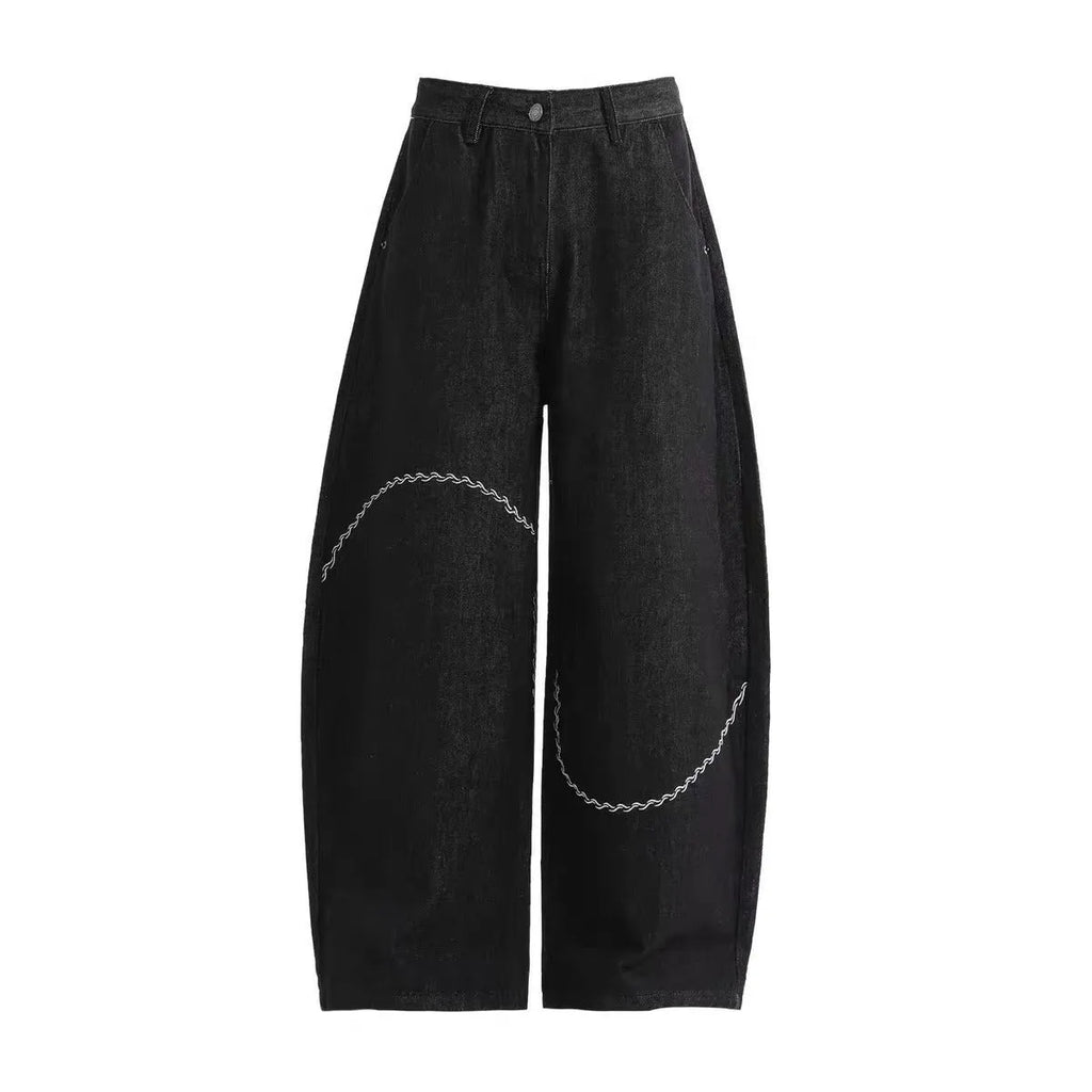 Black straight-leg denim trousers for teenagers on a hanger, showing mid-waist and zip fly detail.