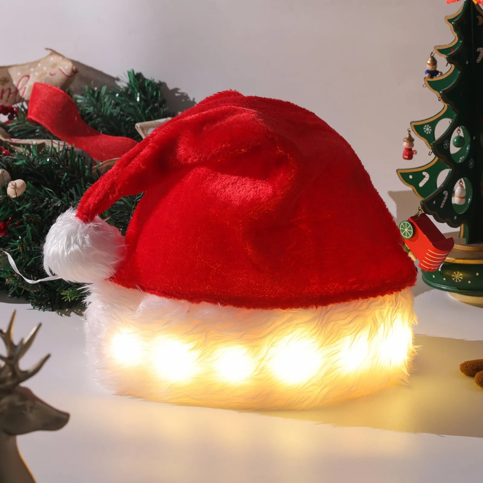 Red and white plush Santa hat with pom-pom and 9 colour-changing LED lights lit up.