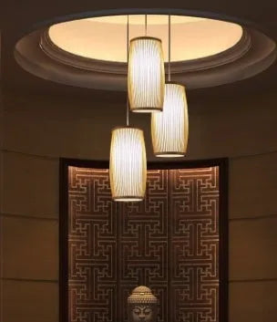 Small woven bamboo table lamp with a natural finish, shown on a wooden surface.