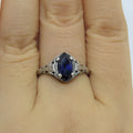 Women's silver geometric hollow ring showing alloy construction and detailed pattern