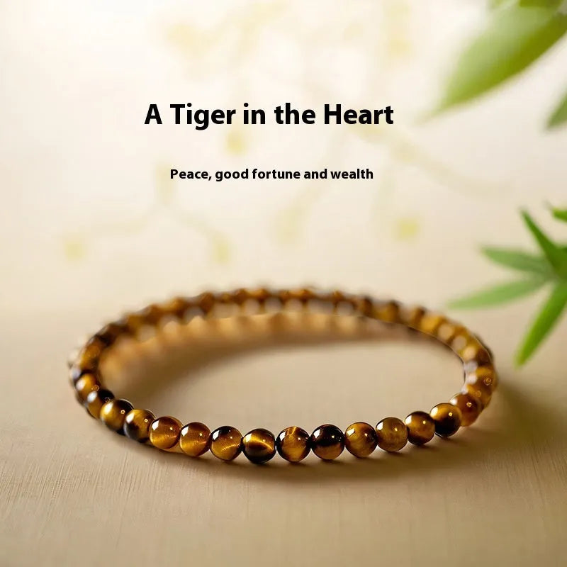 Natural tigereye gemstone bead bracelet in New Chinese geometric style on a wrist.