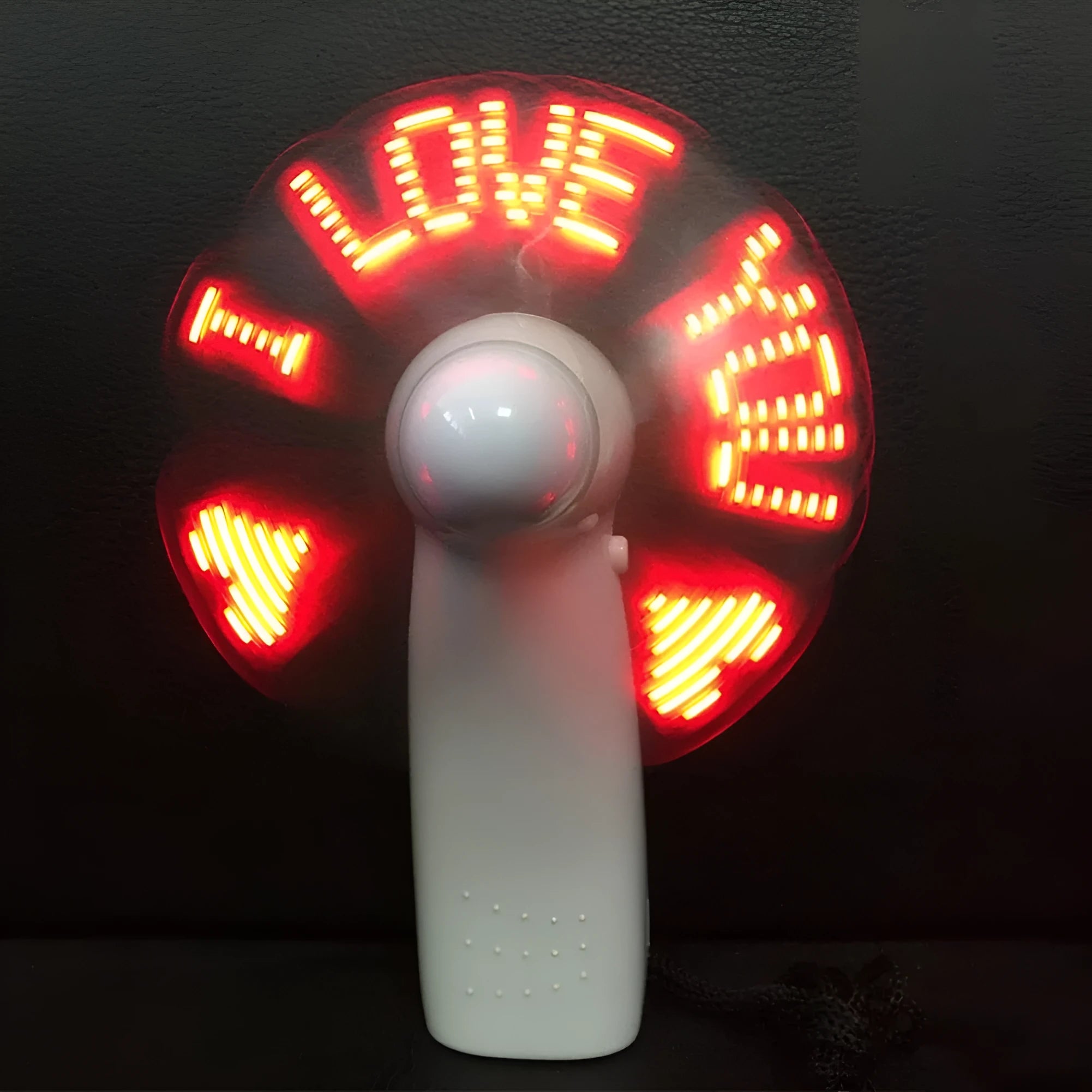 White handheld mini fan with LED lights displaying love pattern and I love you message