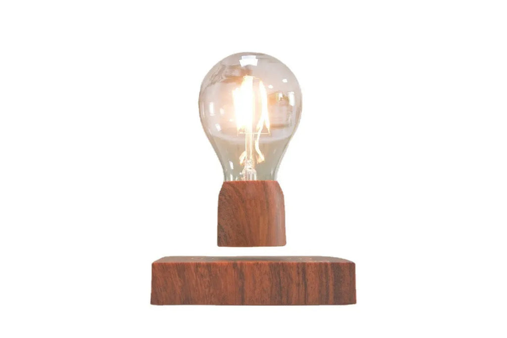 Magnetic levitation floating light bulb with UK plug on imitation wood base.