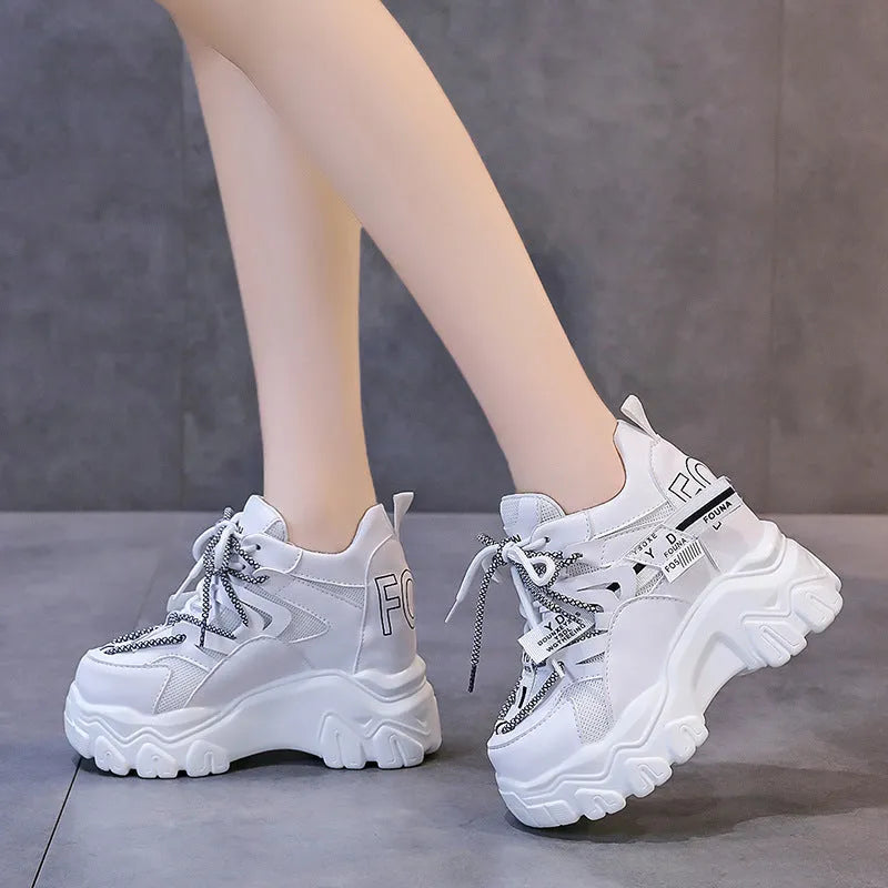 Women's white and black mesh platform sports shoes with cross-strap detail and rubber soles