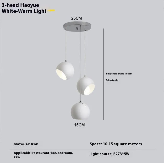 Modern Nordic-style ball chandelier table lamp in Moon White finish on a wooden surface.