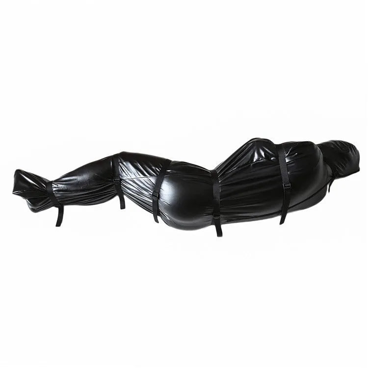 Black patent leather bondage restraint kit with body wrap and six ratchet tie-down straps laid out.