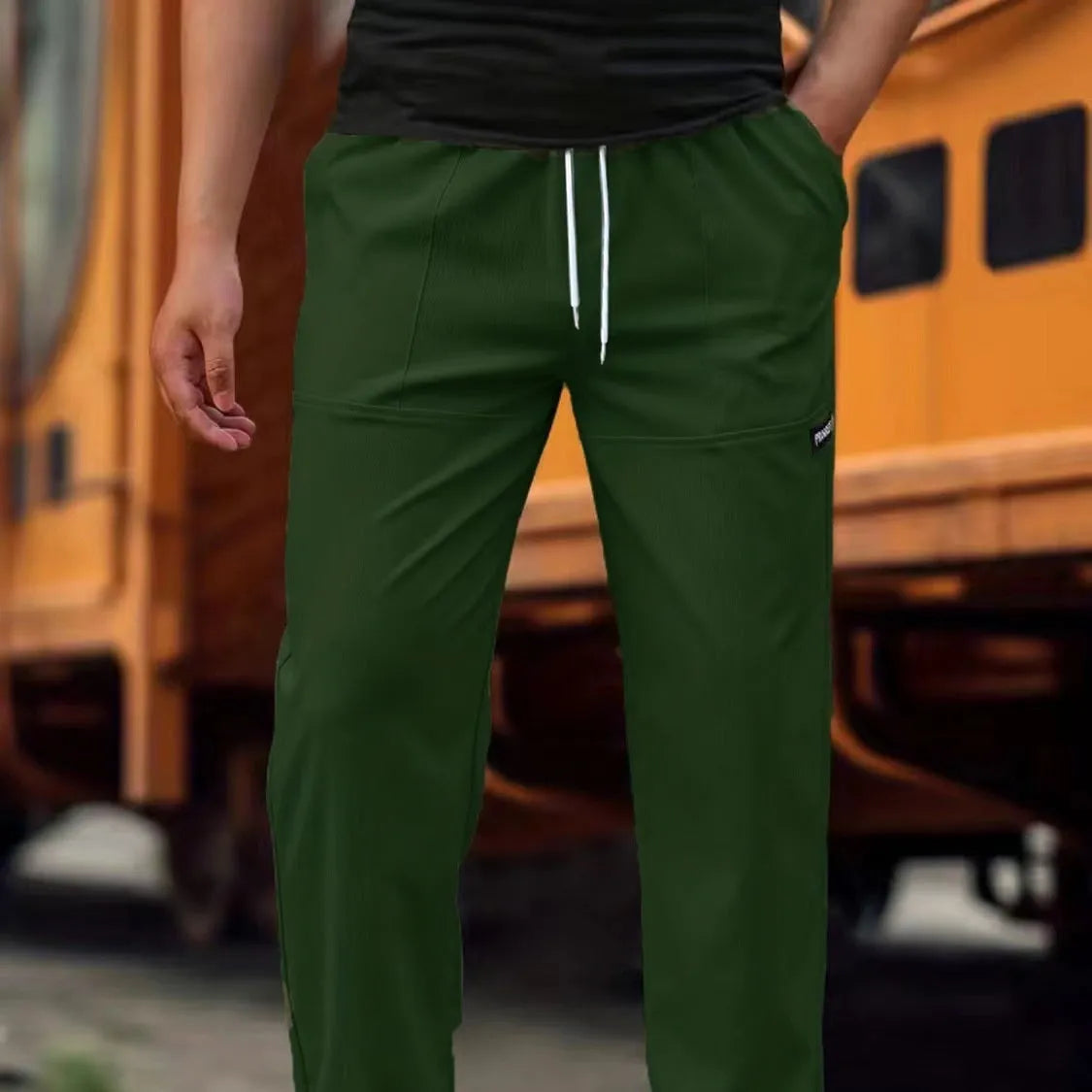 Men's lightweight polyester casual trousers in light grey colour shown flat