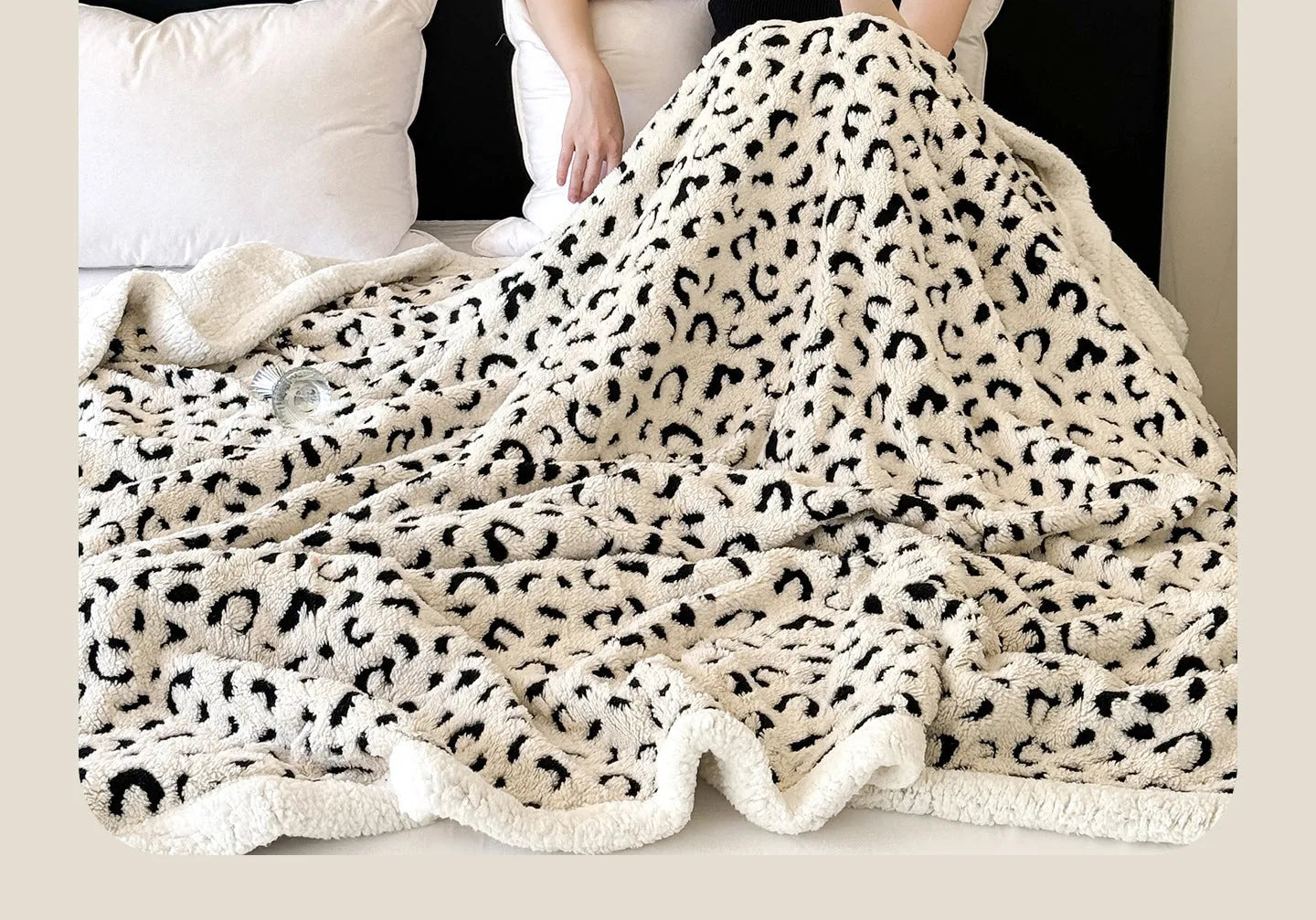 Double-layer cationic leopard jacquard taffeta blanket showing leopard print pattern in camel colour.