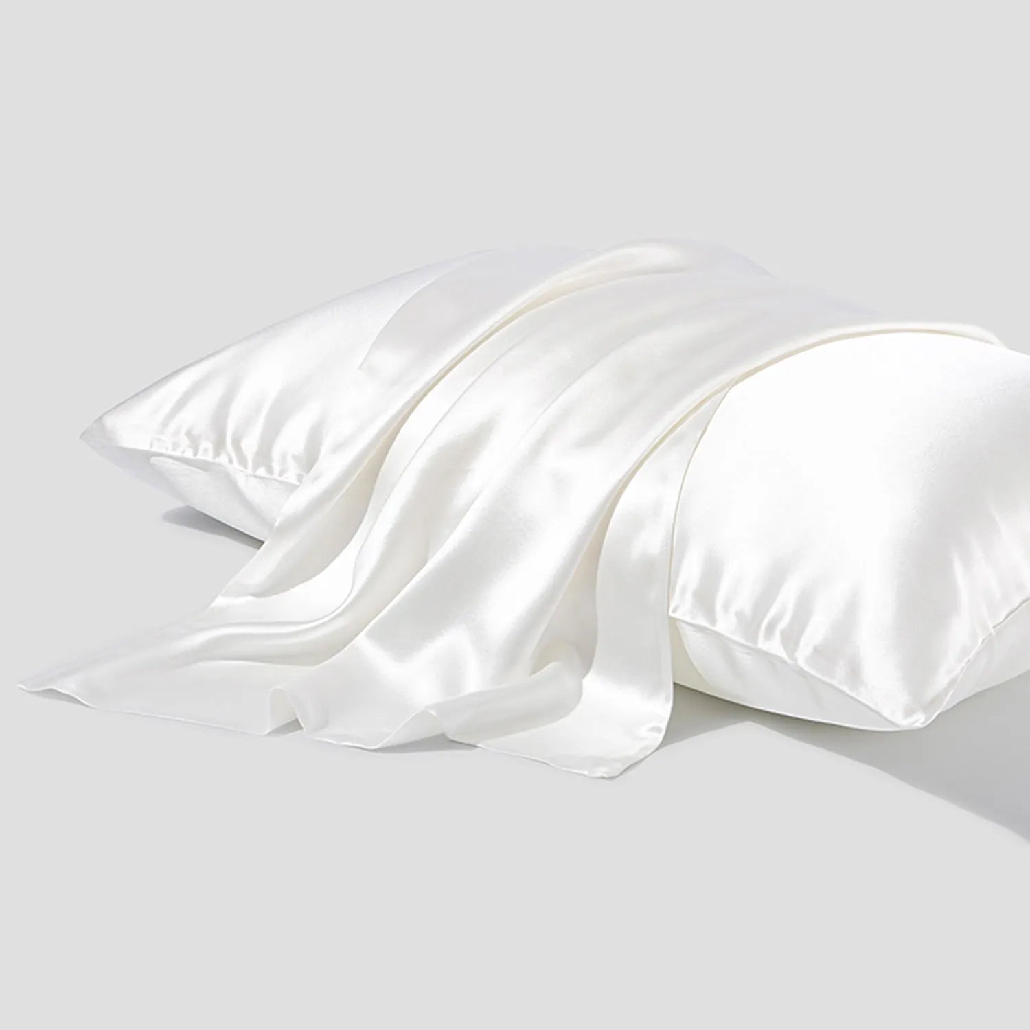 Dark gray envelope closure silk pillowcase on a bed