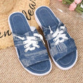 Blue women's flat Roman-style canvas slippers with cloth upper and rubber sole.