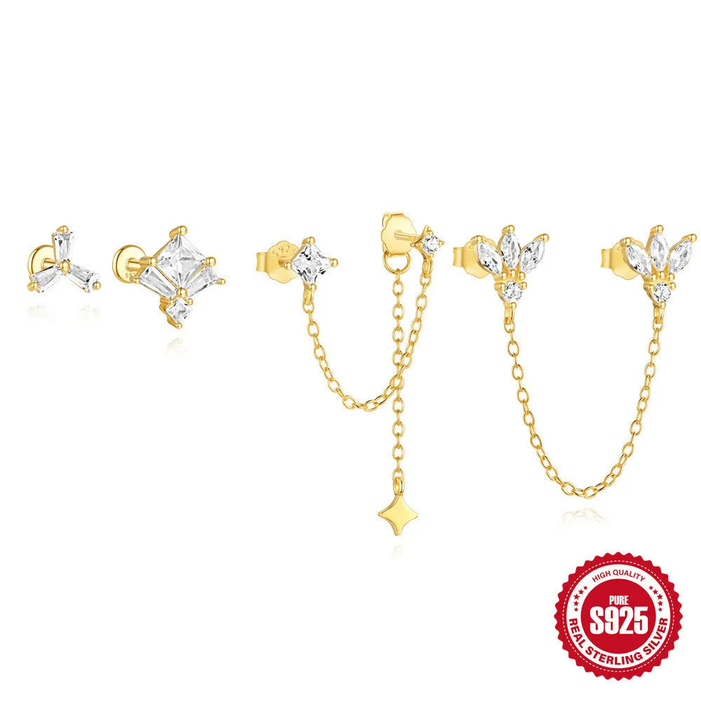 S925 sterling silver stud earrings with zircon inlay in golden geometric designs including clover and crown.
