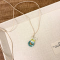 Women's coloured glaze pendant necklace with cotton linen chain featuring Skirt Everyday Joker design