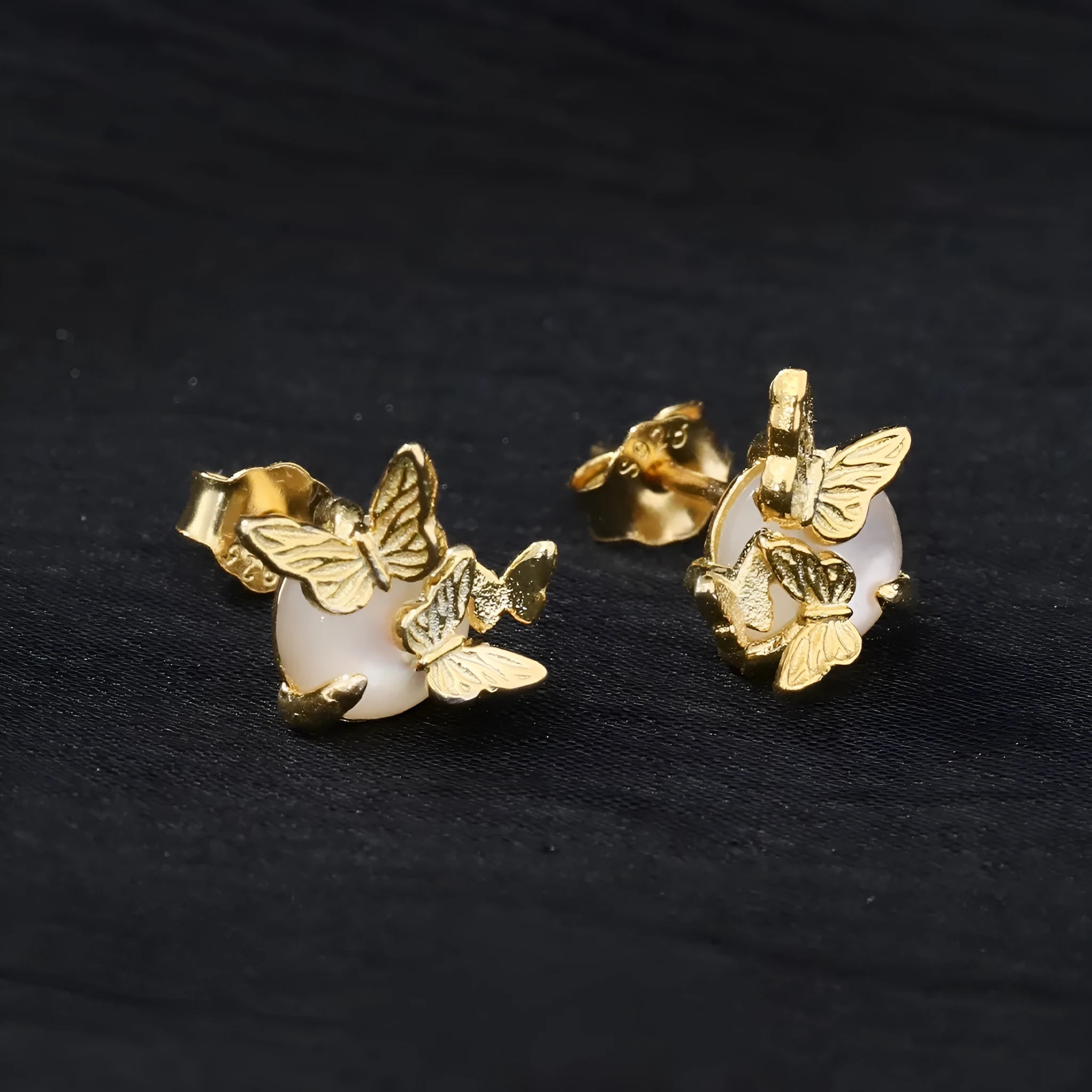 A pair of 925 silver stud earrings with an original butterfly and animal design in a gold colour finish.