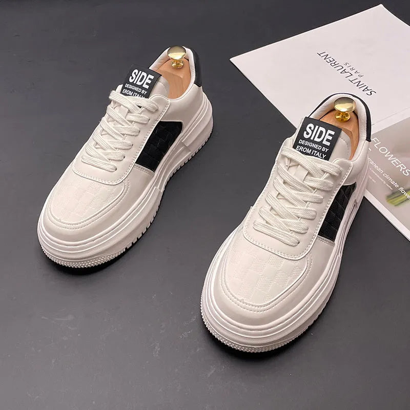 White and green sports casual shoes with cloth upper and rubber foam sole on a plain background.