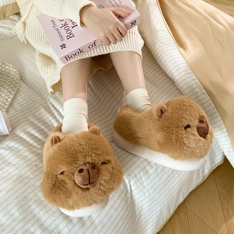 Light brown women's plush winter slippers with a round toe and slip-on design on a white background.