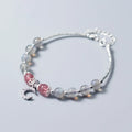 Natural moonstone bracelet with silver crescent moon charm on an adjustable chain.