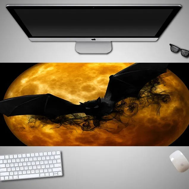 Oversized Halloween-themed computer mouse pad with non-slip rubber cloth base on a desk