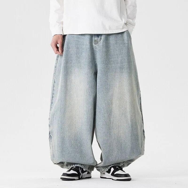 Men's plus-size baggy jeans in light blue denim with straight legs and low waist.