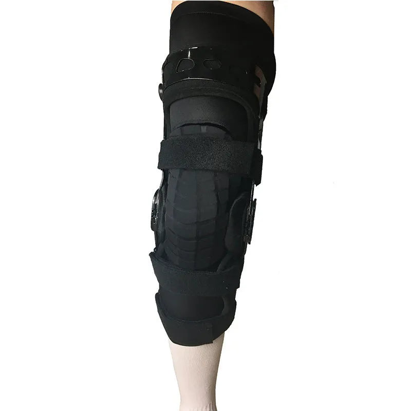 Black adjustable anterior ligament knee support with straps, shown on a leg.