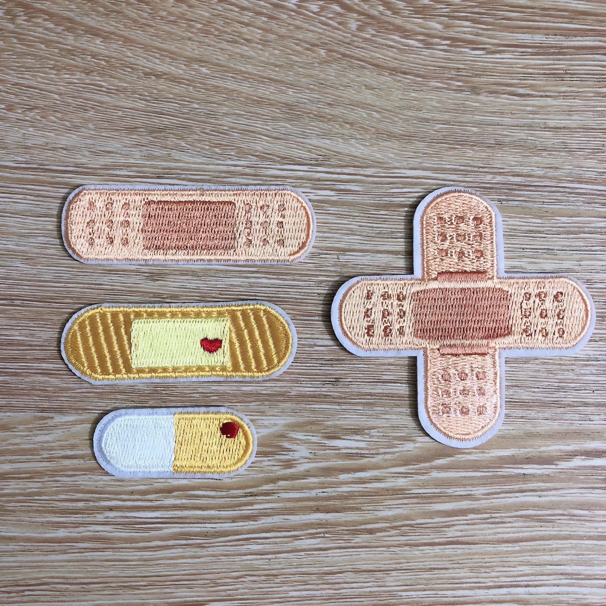 Pack of ten embroidered iron-on cloth patch badges for clothing and craft customisation.