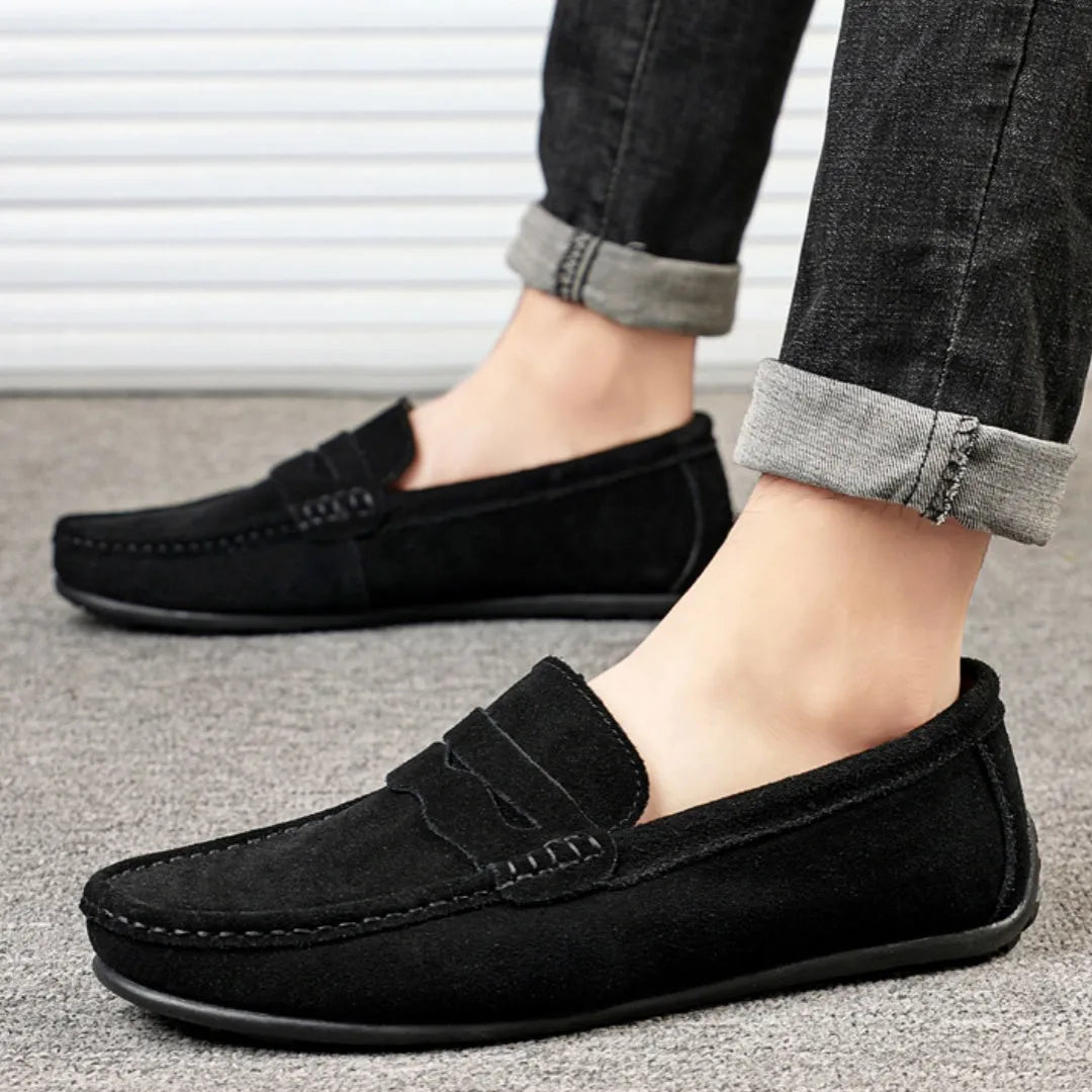 Men's suede slip-on loafers in a solid colour with a round toe and flat rubber sole.