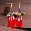 A pair of bohemian-style round drop earrings with a feather leaf pattern, shown in one of thirteen available colours.