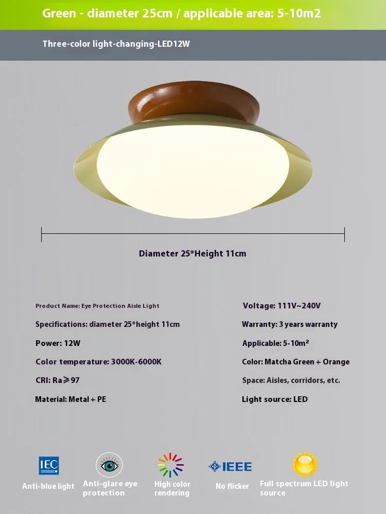 Modern minimalist flying saucer design ceiling lamp in cream yellow on a white ceiling.