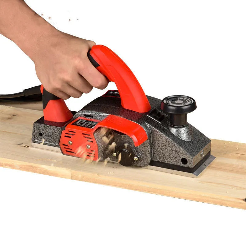 Red aluminium shell electric wood planer tool showing 82mm planing width
