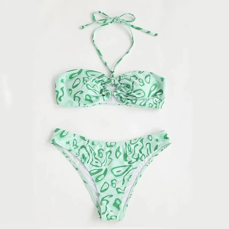 Green floral bandeau bikini swimsuit with split design on a mannequin