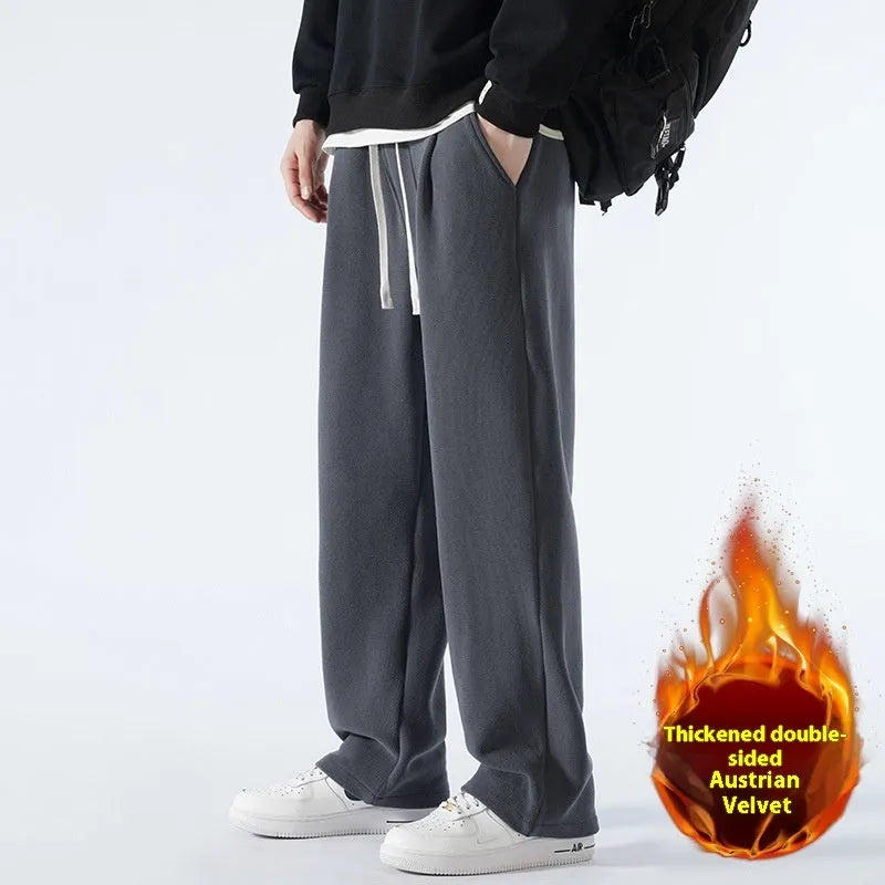 Men's thick apricot coloured fleece-lined loose fit casual sports trousers on a hanger.