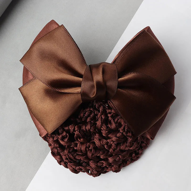 Professional flower bow headdress hair clip ornament on a work plate, shown in a selection of net and mesh colour variations.