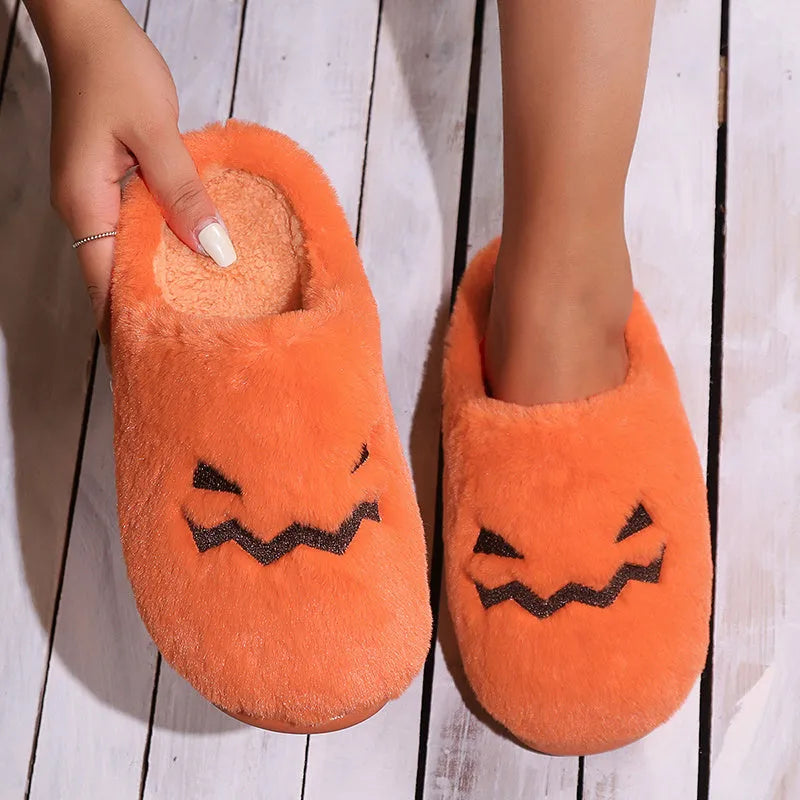 Orange women's pumpkin-themed plush slippers with a coral velvet upper and a flat non-slip sole.