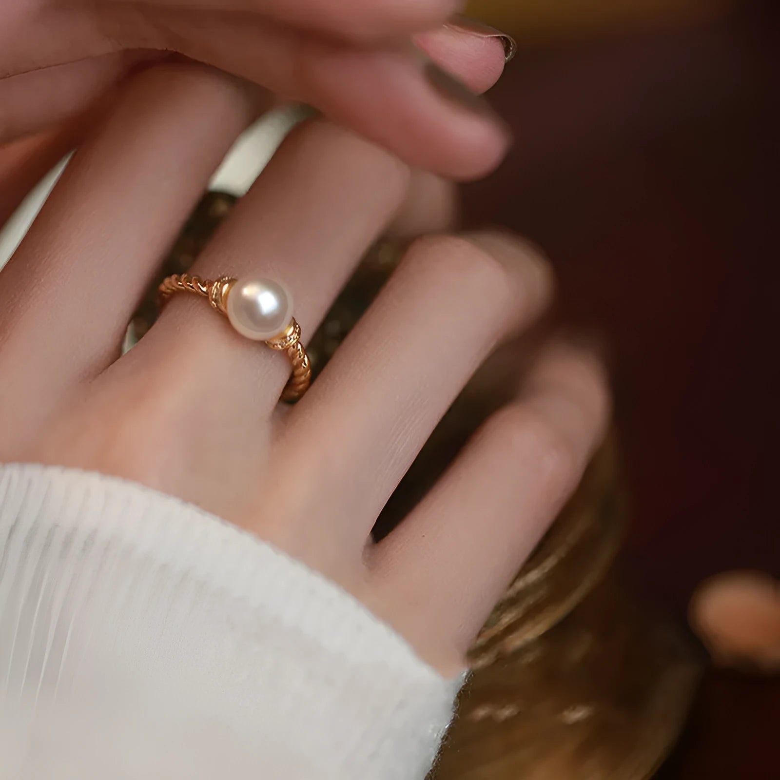 Adjustable antique twist ring with a pearl inlay, shown in gold and silver copper finish.