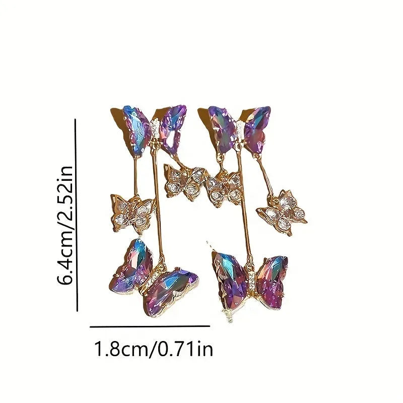 Silver electroplated alloy drop earrings with a blue purple butterfly charm and crystal flower details on a tassel.
