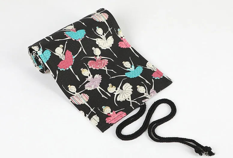 Square canvas pencil case with ballet girl print, showing multiple holes for storing sketching pencils and colour leads.