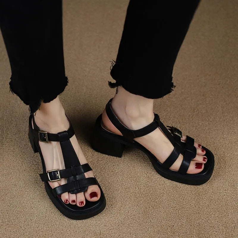 Black women's retro platform sandals with a T-buckle strap and chunky heel.