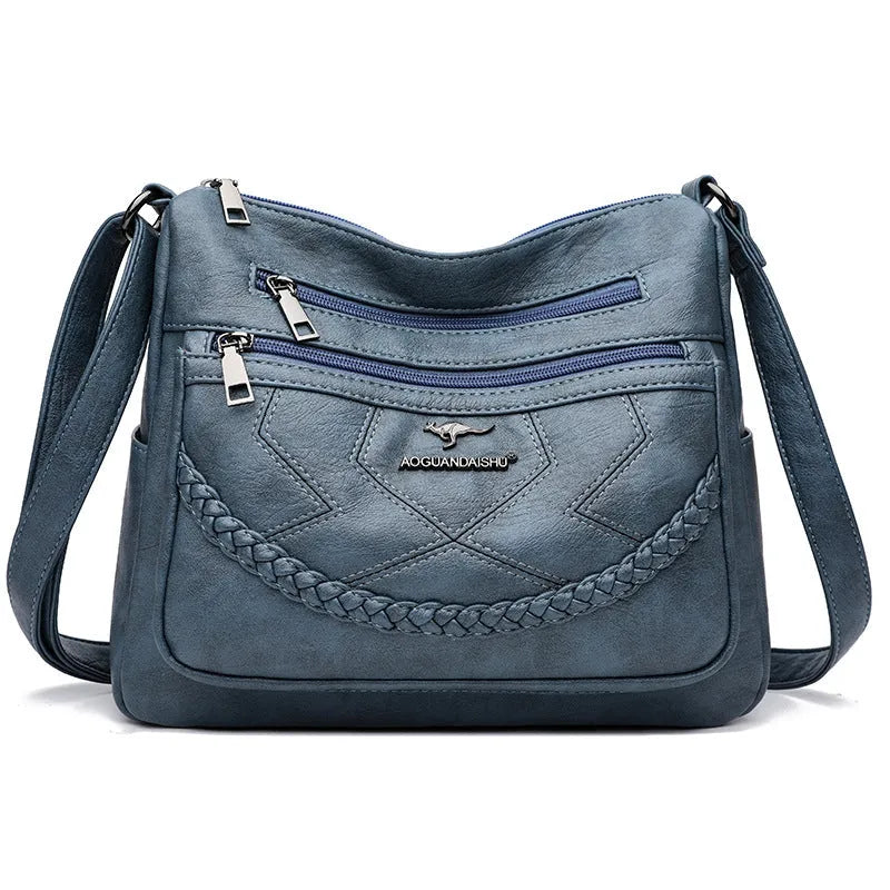 Soft PU leather shoulder bag in horizontal square shape, shown in one of four colours with crossbody strap