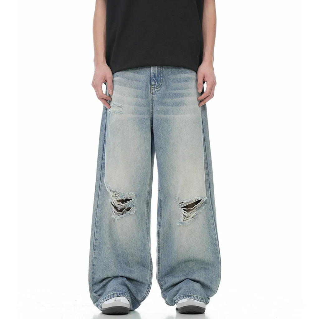 Men's blue straight-leg jeans with ripped detailing on the legs and a zipper fly closure.
