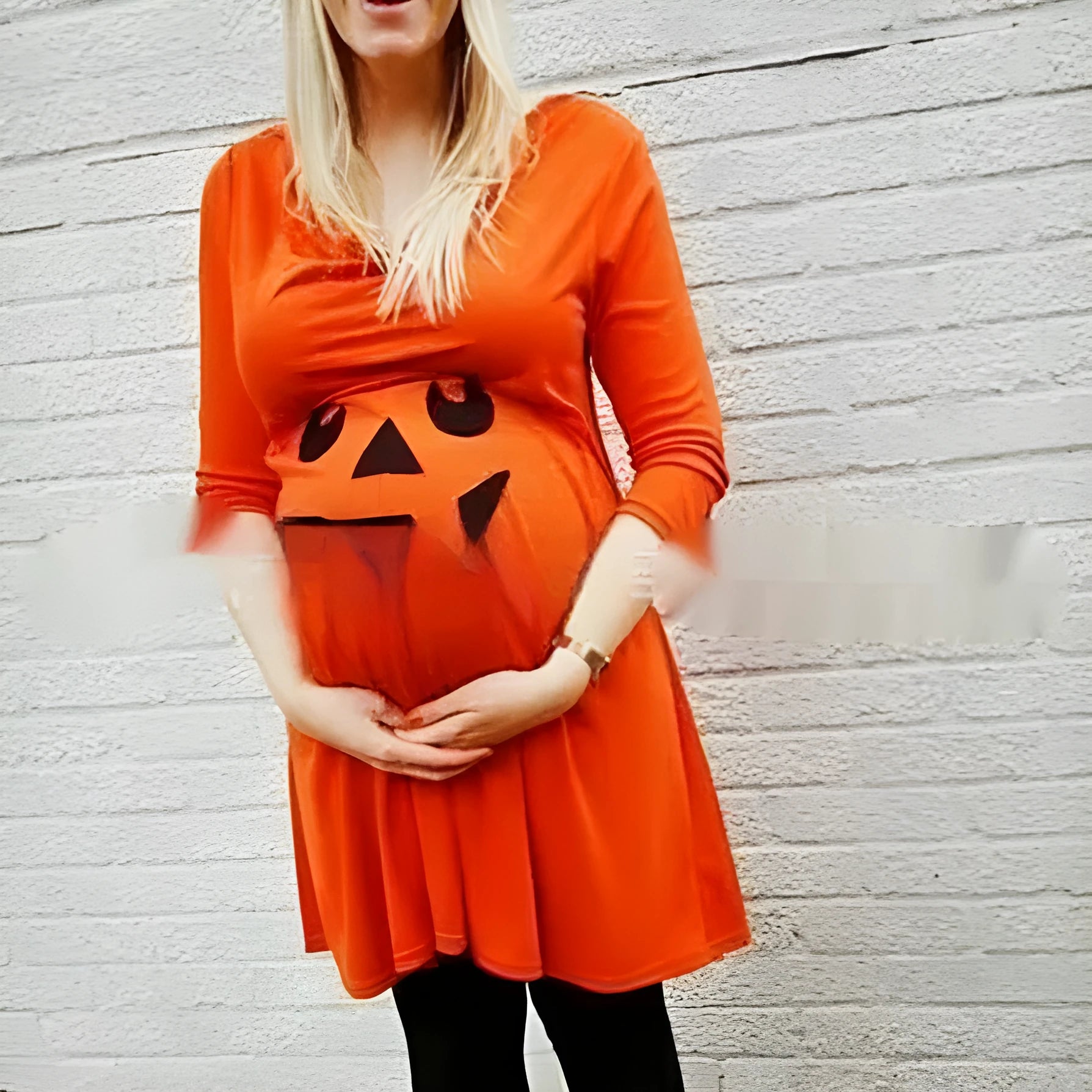 Orange cotton maternity dress on a hanger, showing the style and colour.