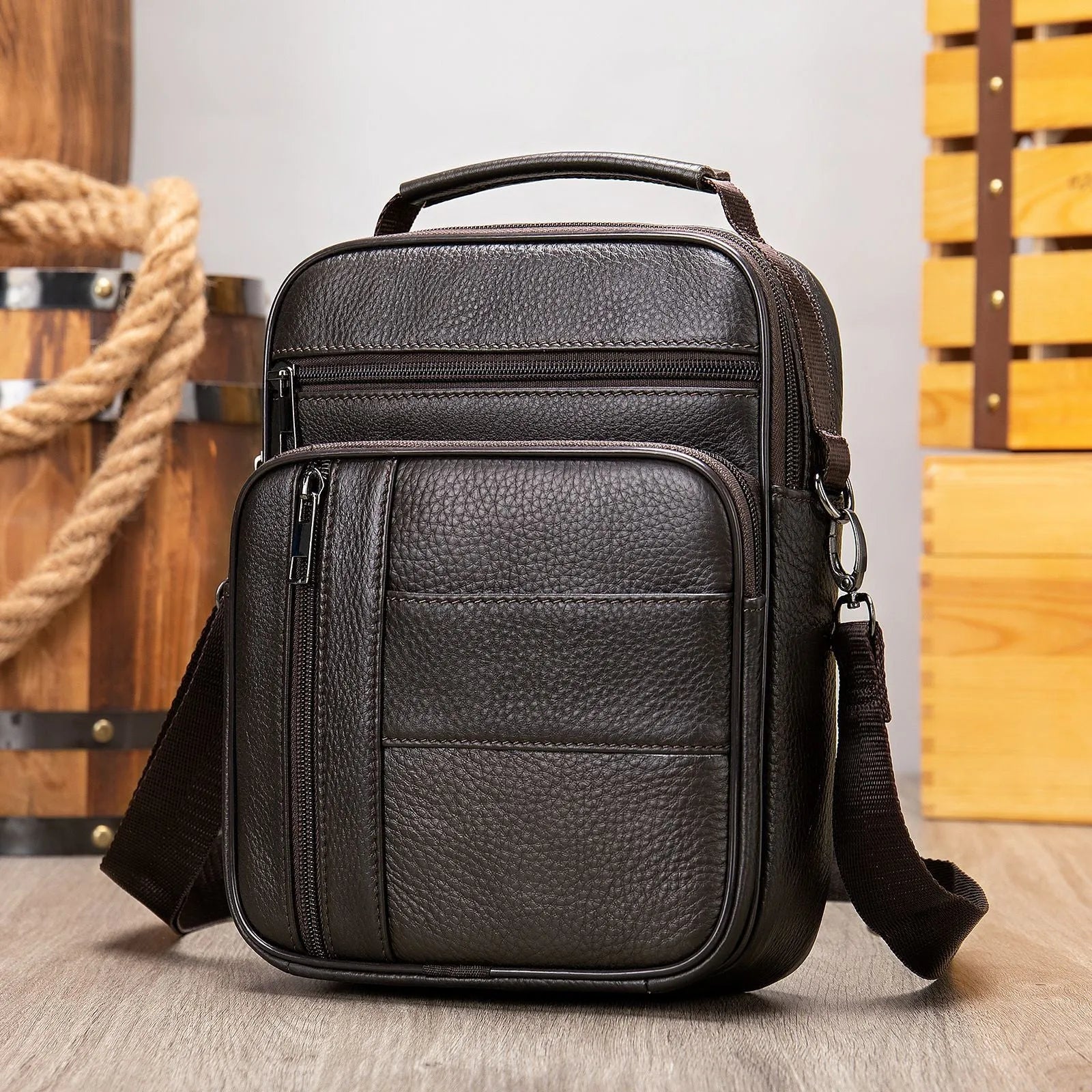 Men's black genuine leather vintage shoulder bag with a soft handle, shown closed.