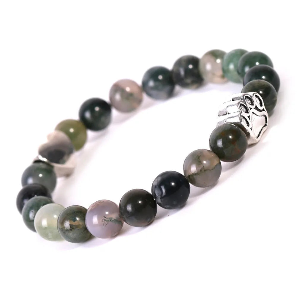 A round beaded stone bracelet in a Tiger Eye or Indian Agate style on a wrist.