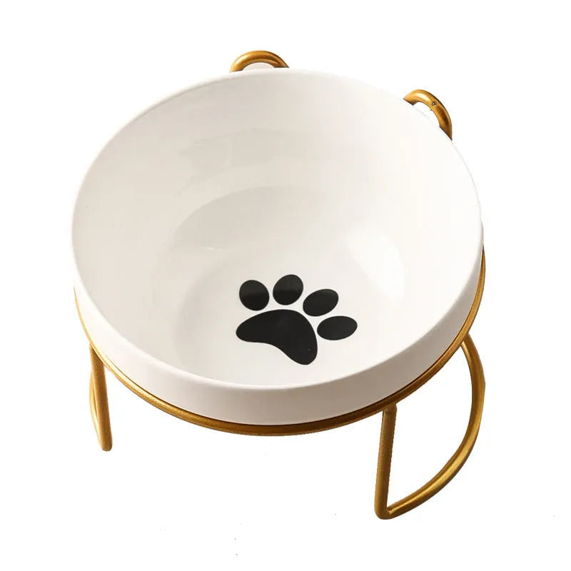 White ceramic pet bowl with cat paw design on a black metal stand with cat ear details.