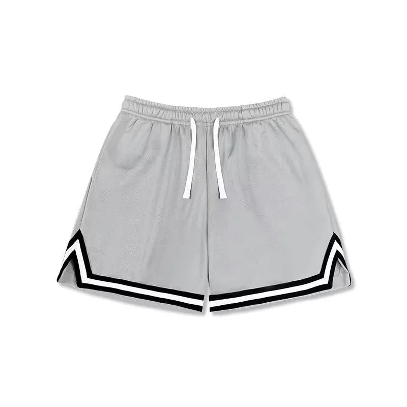 Man wearing loose-fit grey polyester leisure shorts overalls for summer sports.