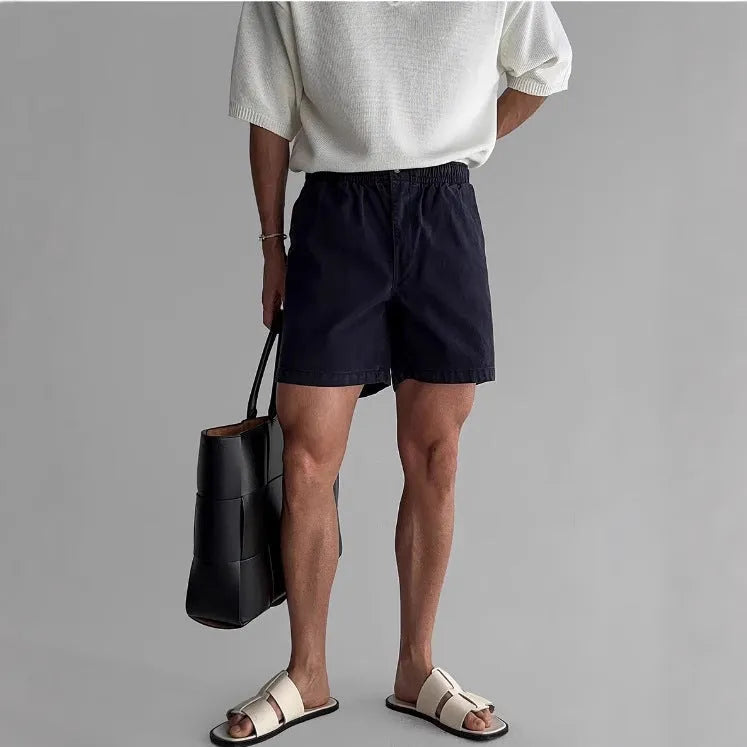 Men's loose-fit cotton sports shorts in black, shown on a white background