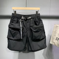 Man wearing large size black loose-fit work shorts with pockets, showing above-the-knee length.