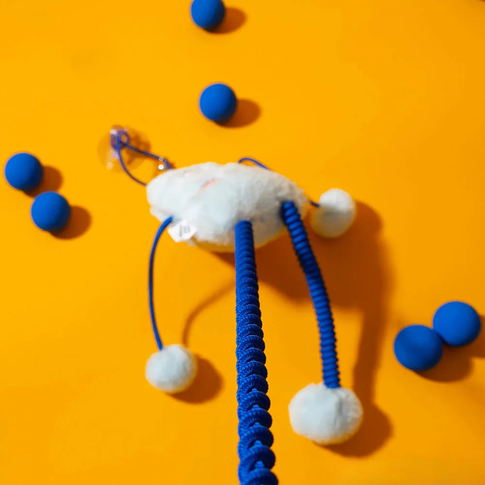 Blue telescopic elastic cat toy with plush ring and mint bell attachment on elastic rope