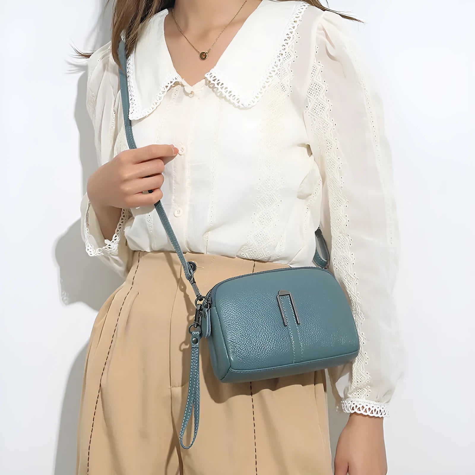 Women's genuine leather square shoulder bag in dark khaki colour, showing its structured shape and shoulder strap.