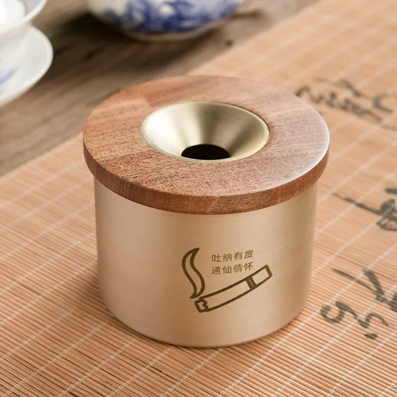 Brass ashtray with a wooden lid featuring a central hole, shown in black wood and red wood options.